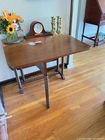 Full view of drop-leaf table showing barley-twist legs and top