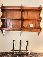 Wall shelf mounted on wall above coat rack
