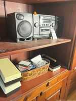 Front view of Sony stereo system with speakers on shelf