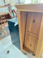 Overall view showing black trunk body and attached pine cabinet section