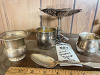 Group shot of all five silver items on shelf