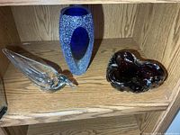 All three glass items on shelf
