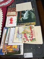 Overview of assorted calendars, planners and note cards on table