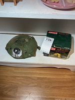 Canteen with canvas cover and boxed Coleman air pump side by side