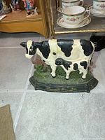 Front view of cast iron cow and calf doorstop