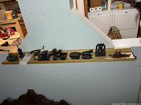 Full shelf view showing all miniature metal pencil sharpeners lined up