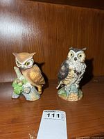 Front view of both porcelain owl figurines