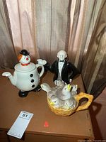 All three figural teapots on surface