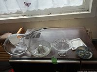 Group shot of decanter, juicer, pedestal bowl, shell-inlay bowl on surface