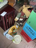 Group shot showing plush moose, planter, signs, doorstops