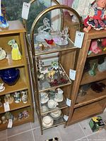 Full view of metal display shelf with contents for scale