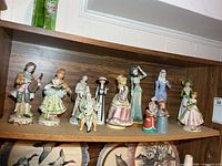 Full view of ten figurines lined on shelf