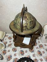 Full view of globe on wooden stand