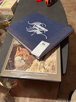 Stacked view showing both books, blue Romance-titled book on top and Robert Bateman book below