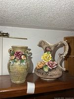 Both ceramic vases on shelf