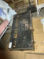 Top view of black metal military box with yellow stenciled lettering