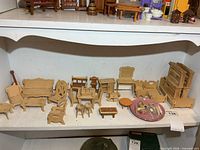 Overview of multiple miniature furniture pieces on shelf