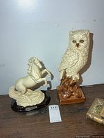 Front view showing both owl and horse sculptures together with scale
