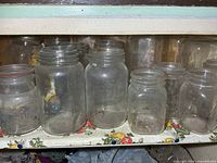 Front view showing majority of jars in situ on shelf