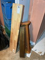 Sealed 36 in Threshold shelf with barcode label, two brown wall shelves beside it