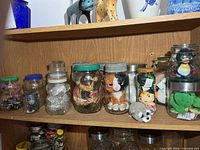 Top shelf showing all eight jars with contents visible