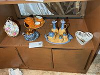 Full lot overview showing all ceramic pieces on shelf