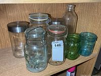 Group of glass jars and canisters on shelf