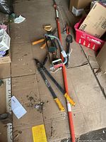 Group shot of all yard tools on cardboard floor