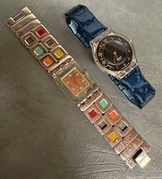 Two Swatch watches laid flat, showing overall design and condition