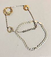 Both bracelets arranged together showing designs and clasps