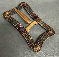 Front view of ornate brass belt buckle
