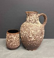 Pitcher and cup front view showing lava texture and relative sizes