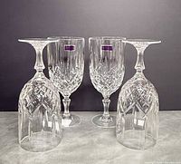 Front view of four crystal iced beverage glasses, two upright two inverted