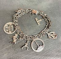 Overall view of sterling charm bracelet showing chain and attached charms