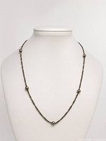 Necklace displayed on bust form showing full design and bead spacing