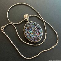 Full view of sterling chain and oval titanium druzy pendant