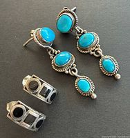 Front view of both earring pairs showing stones and silverwork
