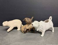 Group shot: stoneware bird, polar bear figurine, cow creamer