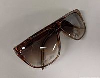 Angled top view highlighting frame pattern and lens gradient
