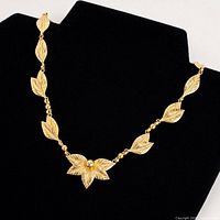 Full view of articulated gold-tone sterling silver leaf necklace