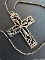 Front view of sterling silver cross pendant on chain