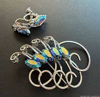 Brooch and both screw-back earrings front view highlighting AB rhinestones and sterling setting