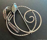 Front view showing hematite stone and scroll design
