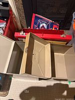 Open beige folding storage case showing three hinged compartments