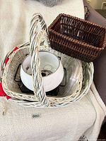 All items grouped in white basket showing fondue pot, glass lid, brown basket corner