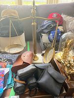Overall lot showing balance scale, three binoculars and cases