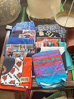 Top view of stacked colorful bandanas showing variety of patterns and colors