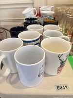 Group of assorted mugs showing quantity and variety
