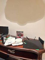 All items on desk including WD drive, wireless access points, Salamander adapter packaging, glass shelf