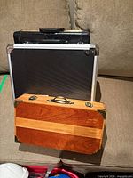 Three briefcases grouped on sofa showing fronts and handles